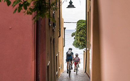 girl and mom riding in the street