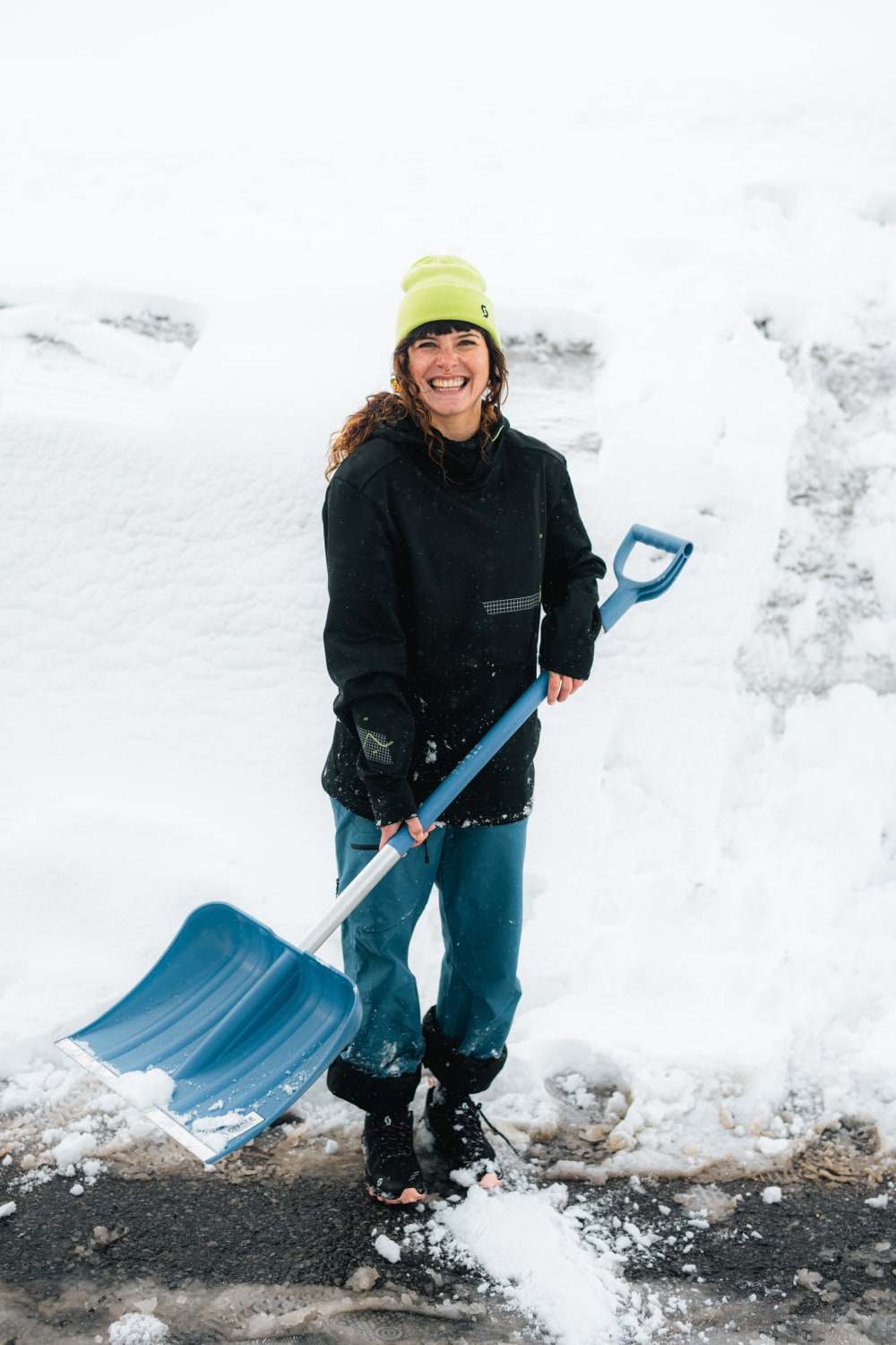 smiling girl showeling snow